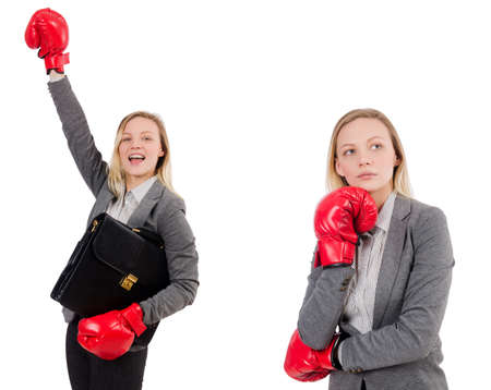 Woman businesswoman with boxing gloves on whiteの写真素材