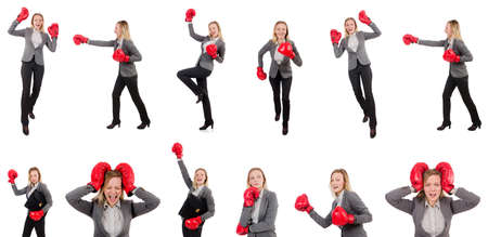 Woman businesswoman with boxing gloves on whiteの写真素材