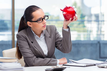 Bankrupt broke businesswoman with piggy bankの写真素材