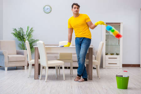 Young man doing chores at homeの写真素材
