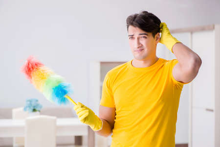Young man doing chores at home