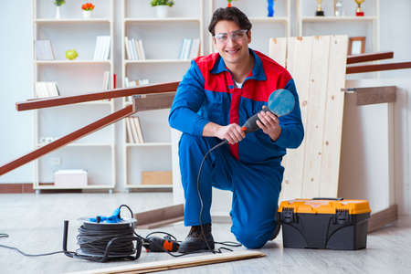 Young carpenter working with wooden planksの写真素材
