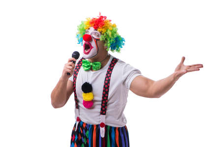 Funny clown with a microphone singing karaoke isolated on whiteの写真素材