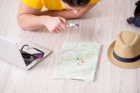 Man planning his vacation trip with mapの写真素材