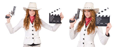 Young   cowgirl with gun  and movie board  isolated on whiteの写真素材