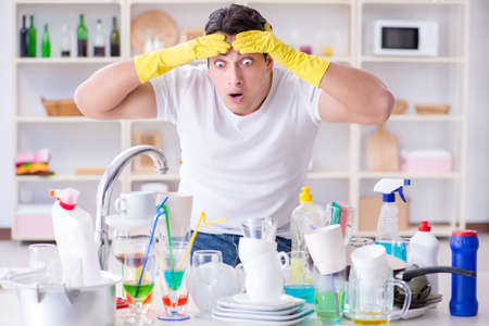 Man frustrated at having to wash dishesの写真素材