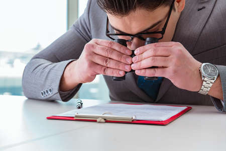 Man looking for errors and mistakes in reportの写真素材