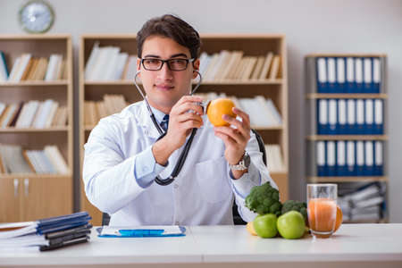 Scientist studying nutrition in various foodの写真素材