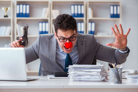 Clown businessman working in the office angry frustrated with aの写真素材