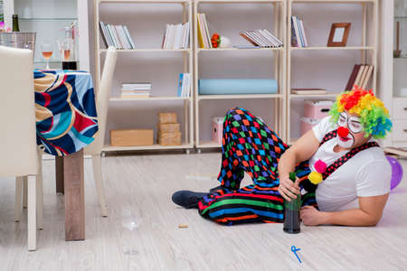 Drunk clown celebrating having a party at homeの写真素材