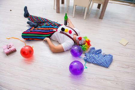 Drunk clown celebrating having a party at homeの写真素材