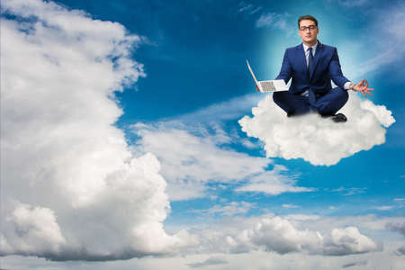 Businessman working on laptop in the sky