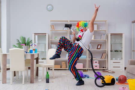Funny clown doing cleaning at homeの写真素材