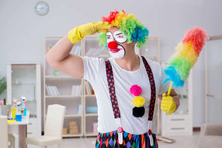 Funny clown doing cleaning at homeの写真素材