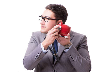 Businessman with stethoscope and piggybank isolated white backgrの写真素材