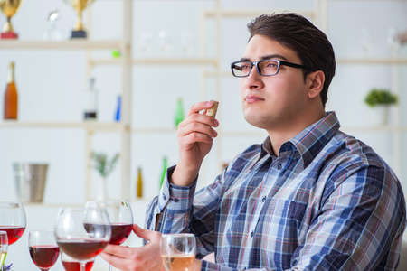 Professional sommelier tasting red wine