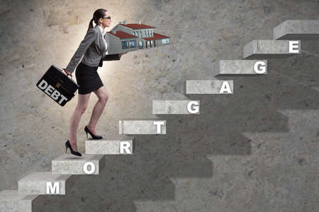 Businesswoman in mortgage debt financing conceptの写真素材