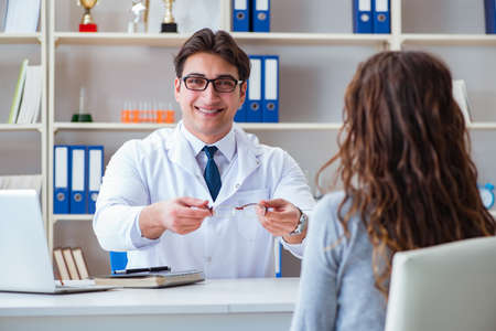 Doctor optician prescribing glasses to a patientの写真素材