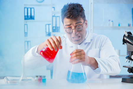 Funny mad chemist working in a laboratory
