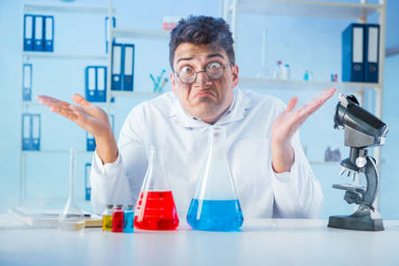 Funny mad chemist working in a laboratoryの写真素材