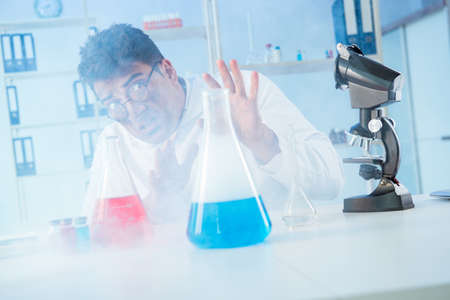 Funny mad chemist working in a laboratoryの写真素材