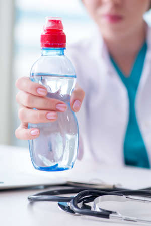 Doctor hand with fresh water in medical conceptの写真素材