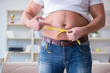 Man suffering from extra weight in diet concept