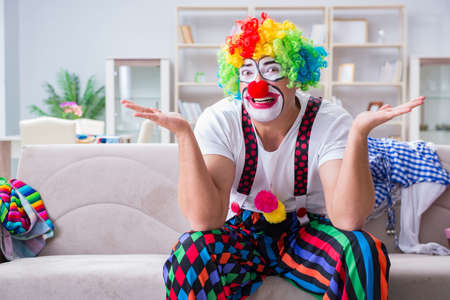 Drunk clown celebrating having a party at homeの写真素材