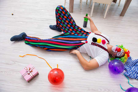 Drunk clown celebrating having a party at homeの写真素材