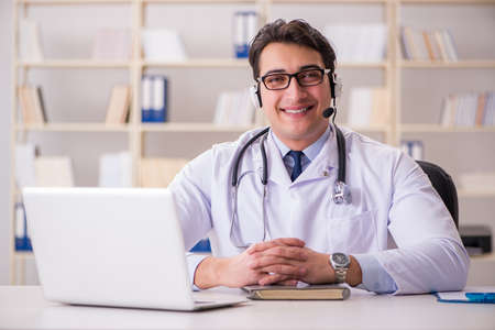 Young man doctor in medical conceptの写真素材