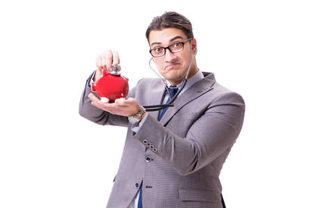 Businessman with stethoscope and piggybank isolated white backgrの写真素材