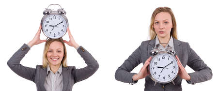 Businesswoman in gray suit holding alarm clock isolated on whiteの写真素材