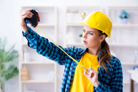 Woman in workshop with measuring tapeの写真素材