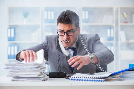 Businessman smoking in office at workの写真素材