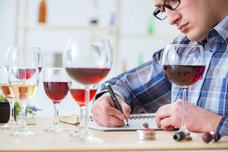 Professional sommelier tasting red wineの写真素材
