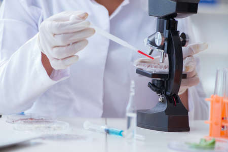 Female scientist researcher conducting an experiment in a laboratoryの写真素材
