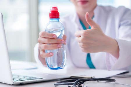 Doctor hand with fresh water in medical conceptの写真素材