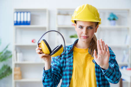 Woman in workshop with noise cancelling headphonesの写真素材