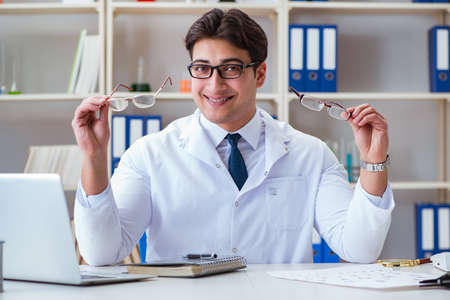 Doctor optician prescribing holding optical glassesの写真素材