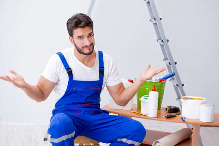 Repairman doing renovation repair in the house with paper wallpaの写真素材