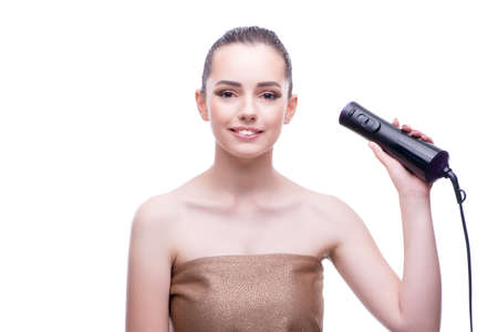 Woman in beauty concept with hair dryer blower dryingの写真素材