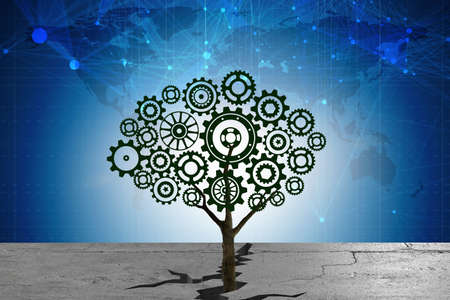 Cogwheel tree growing through soil crackの写真素材