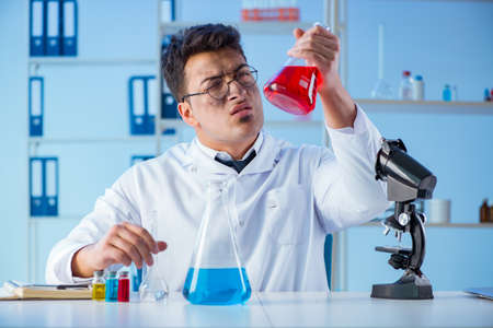 Funny mad chemist working in a laboratoryの写真素材