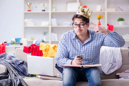 Young man working studying in messy roomの写真素材