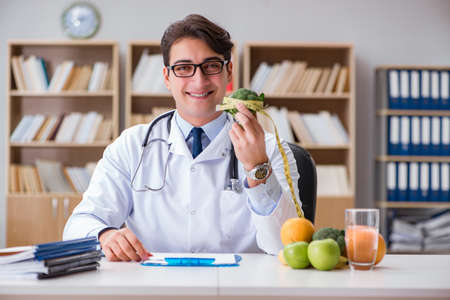 Scientist studying nutrition in various foodの写真素材