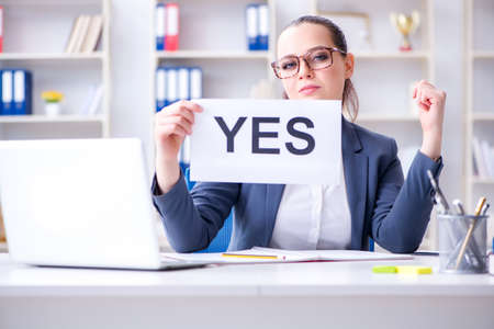 Businesswoman with yes message in officeの写真素材