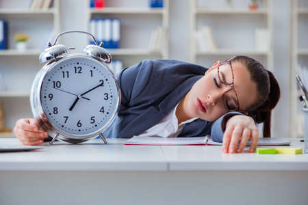 Businesswoman in time management concept sleepingの写真素材