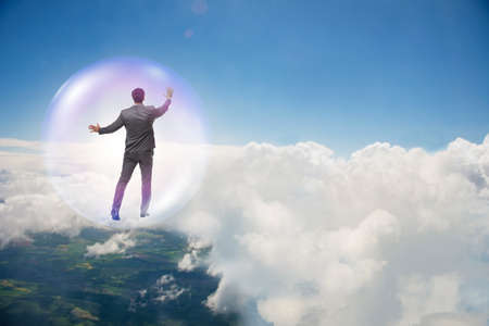 Businessman flying inside the bubbleの写真素材