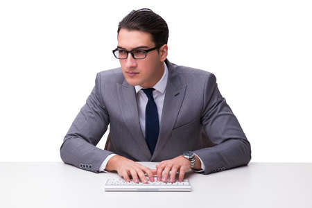 Young businessman typing on a keyboard isolated on white backgroの写真素材