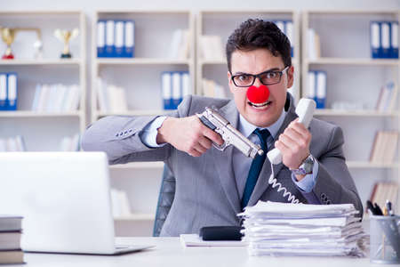 Clown businessman working in the office angry frustrated with aの写真素材